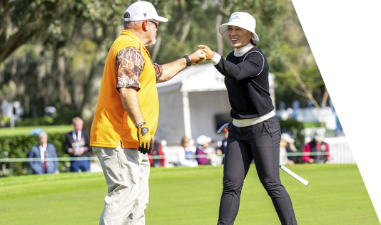 Golfers giving a high five on the golf course